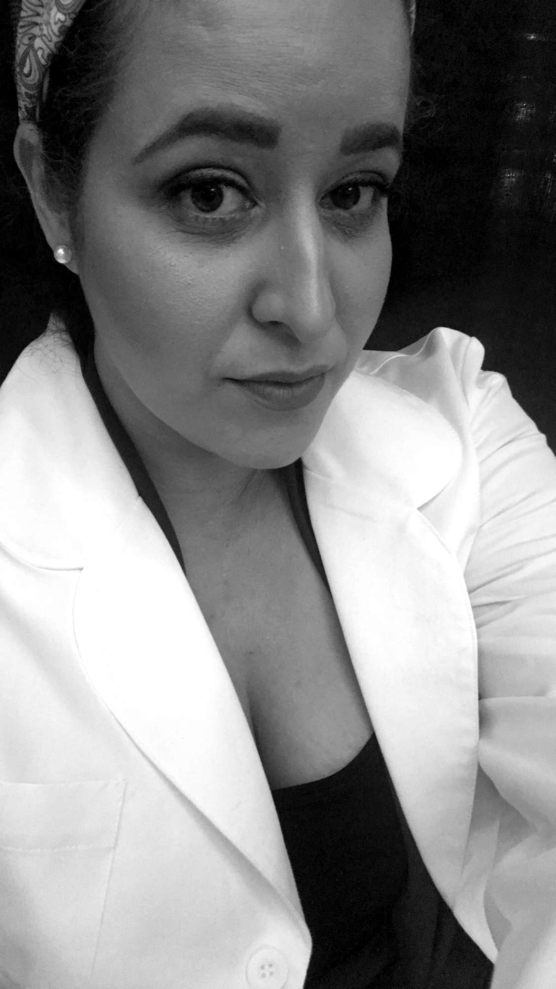 A selfie of Ana wearing a white blazer